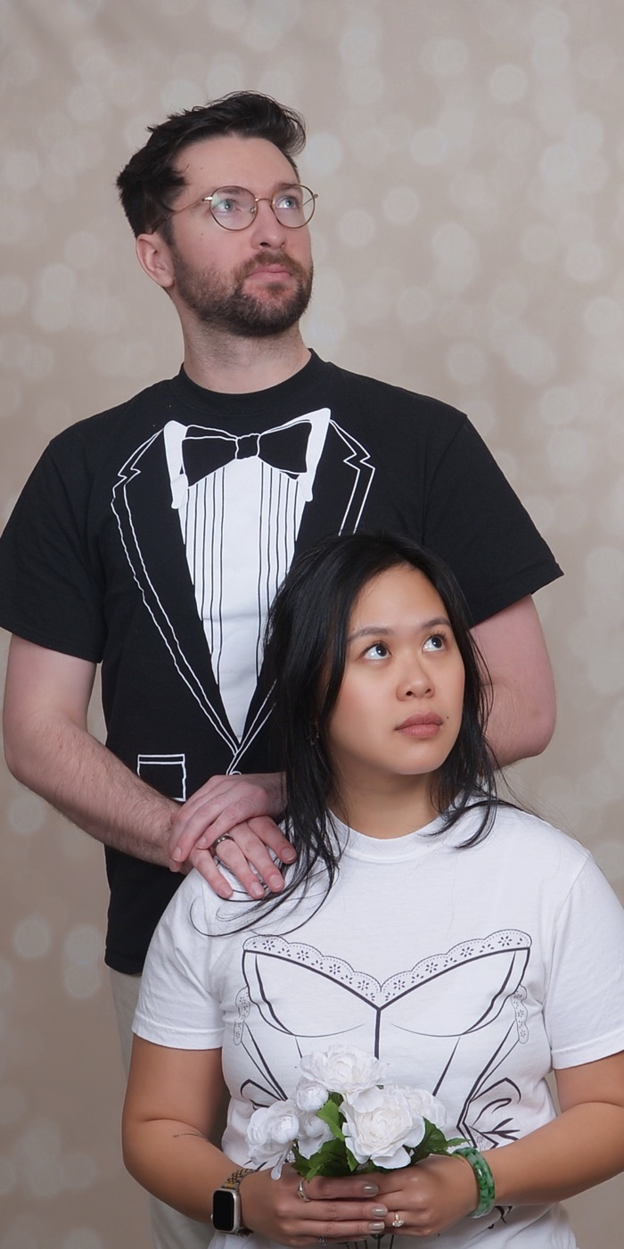 Derek standing behind Nhi, who holds a bouquet