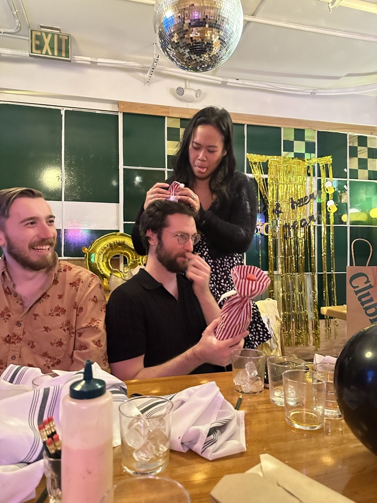 Derek and Nhi celebrating with friends